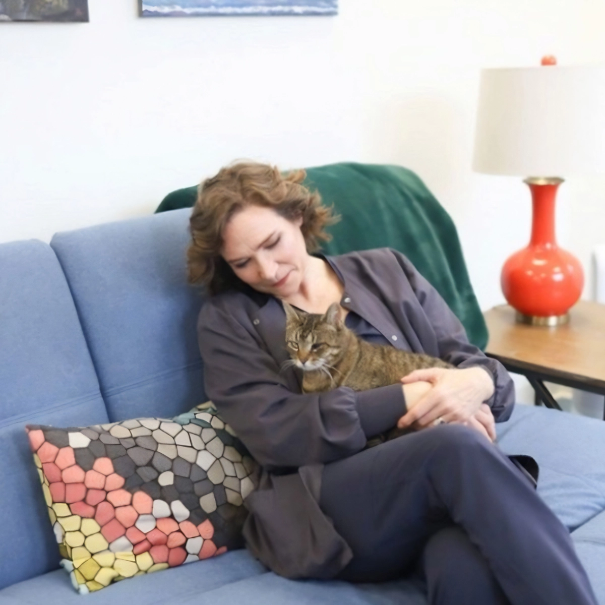 Dr. Kelly Hill sitting on a couch with her cat 